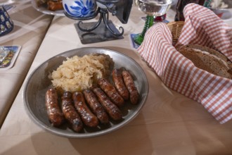 Nuremberg sausages with sauerkraut served on a pewter plate, Nuremberg, Middle Franconia, Bavaria,