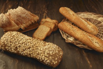 Varied bread still life over dark wood background