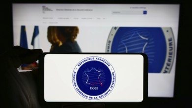 Stuttgart, Germany, 11-27-2023: Person holding mobile phone with logo of Direction Générale de la