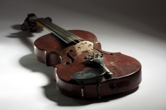 Extremely old master violin on light background