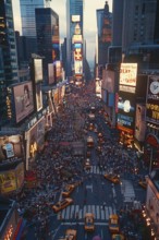 Dense crowd on a busy city street in New York city with skyscrapers, taxis, and billboards at dusk,