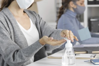 Close up woman using disinfectant. High resolution photo