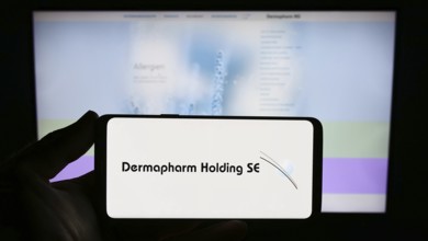 Stuttgart, Germany, 08-21-2023: Person holding smartphone with logo of German pharmaceutical