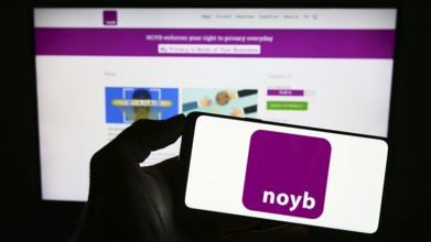 Stuttgart, Germany, 07-31-2023: Person holding mobile phone with logo of NOYB ? European Center for