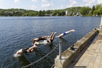 Summer, boys jumping into a lake, Saint Agathe, Province of Quebec, Canada, North America