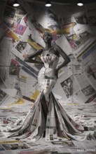 Fashion model poses in a newspaper-crafted dress with a monochrome newspaper background, AI