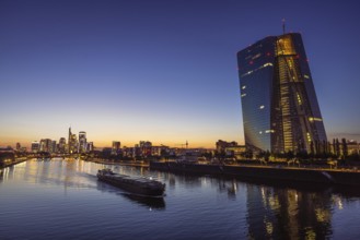 A ship sails past the European Central Bank (ECB) from the Frankfurt banking skyline, Frankfurt am