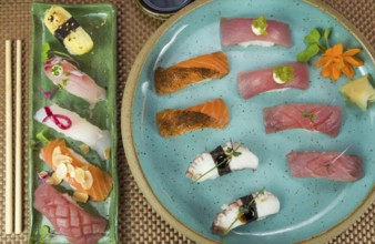 Platter with different types of nigirizushi, nigiri with different fish and one decorated with a