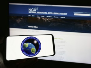 Stuttgart, Germany, 11-11-2023: Person holding cellphone with seal of US National