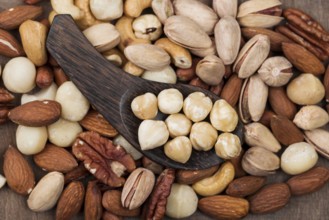 Various organic nuts snack spoon background