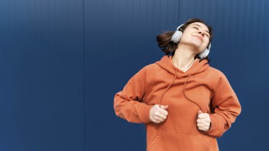 Portrait young woman with headphones jumping7