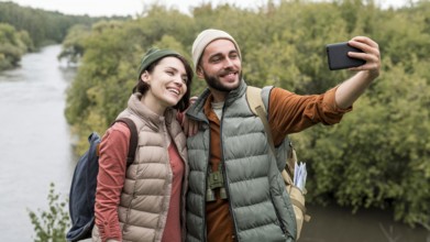 Happy couple taking selfie with smartphone nature