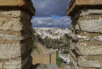 View of the city of ronda, malaga, spain from the city walls under a cloudy stormy sky