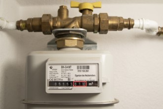Symbolic image of energy costs in the household, natural gas, analogue gas meter in a flat,