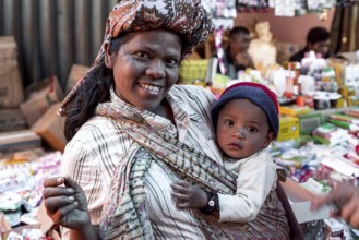 Toba Batak woman with baby in traditional clothing on the weekly market of Pangururan, the main
