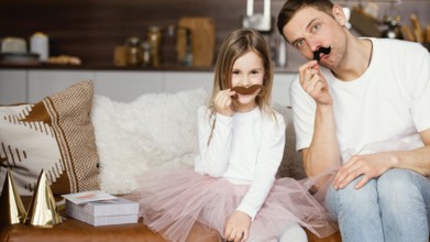 Front view smiley girl tutu skirt father with fake mustaches
