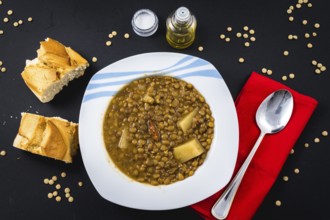 Homemade recipe of a finished Spanish lentil dish, ready to eat with bread