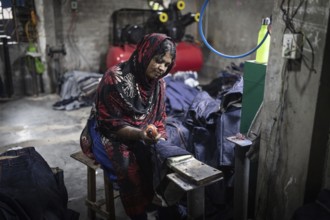 Woman at work in a denim fabric dyeing factory, Dhaka, Bangladesh, Asia