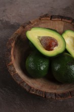 Fresh, sliced avocado, in a wooden plate, top view, food background, concept, food styling