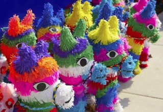 Mexican party pinatas decorated with fringed tissue colorful paper