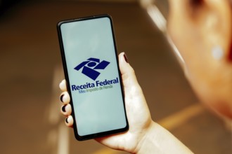 In this photo illustration, the Meu Imposto de Renda (Receita Federal) logo is displayed on a