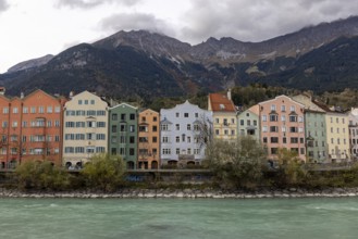 Colourful row of houses on Mariahilfstrasse on the Inn, Tyrolean Alps in the background, Innsbruck,