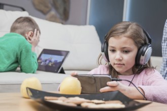 Kids using technologies living room