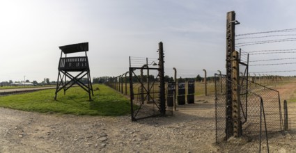 Auschwitz, Poland - 15 September, 2021: guard tower and prison camp gate at Auschwitz concentration