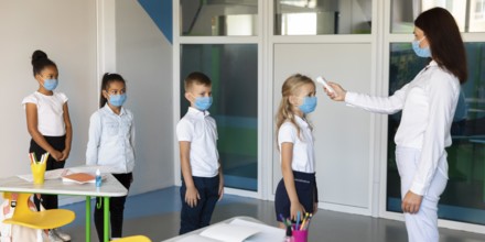 Side view kids waiting line temperature measurements