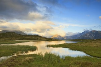Cloudy sky at Jaufenpass, Passo di Monte Giovo, mountain lake, evening mood, Sterzing, South Tyrol,