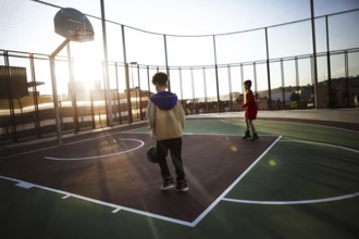Children playing basketball field. High resolution photo