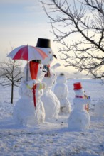 Snowman Family with animal figures, winter landscape Snowman Family with animal figures, winter