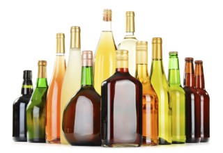 Bottles of assorted alcoholic beverages isolated on white background