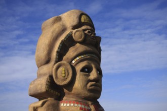 Aztec deity, detail, background blue-white sky