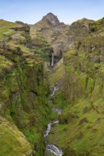 Mountain landscape with green canyon, waterfall and river in Múlagljúfur Canyon, Sudurland,