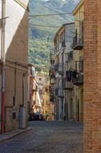 Cobblestone street in the historic centre of the Sicilian town of Castelbuono. Sicily, Italy,