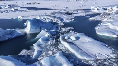 Aerial drone view of floating icebergs in Jokulsarlon glacier lagoon in Iceland