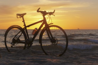 The silhouette of a Bicycle on the beach, Bicycle at sunset