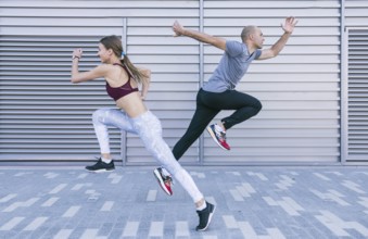 active sportive young male female athlete running jumping air. Resolution and high quality