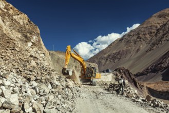 LADAKH, INDIA, SEPTEMBER 10, 2011: Excavator cleaning road after landslide in Himalayas. Ladakh,