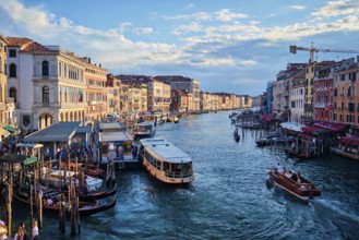 VENICE, ITALY, JUNE 27, 2018: Grand Canal with boats, vaporetto and gondolas on sunset from Rialto