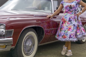Vintage American road cruiser Buick with woman and petticoat