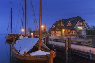 Fischland Brauerei, brewery and traditional sailing boats at dusk in the harbour of Althagen,