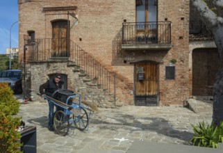 Garbage collectors in the square of Aliano, the very poor village in southern Italy that the writer