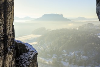View from the Bastei bridge into the misty Elbe valley with the spa town of Rathen and Lilienstein,