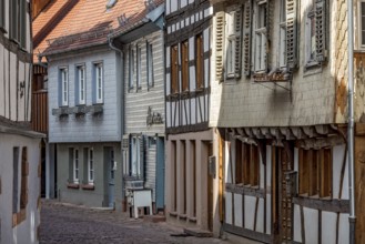 Row of houses with old half-timbered houses and clapboard houses, wooden shingles in pastel