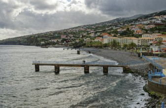 Promenade in rainy weather on the beach of the Atlantic Ocean, municipality of Santa Cruz, Madeira,