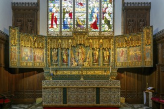 Elaborately carved gilt altar reredos screen 1938, church of Saint John the Baptist, Peterborough,
