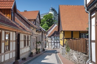 Street with half-timbered houses and cobblestones in the historic old town, behind the castle,