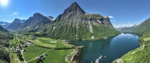 Aerial panoramic view over fjord Hjorundfjord, village Oye with Union hotel (left), marina, mt.